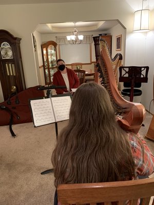 Giving a harp lesson