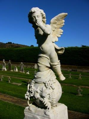 Contemplative angel statue at the Italian Cemetery.