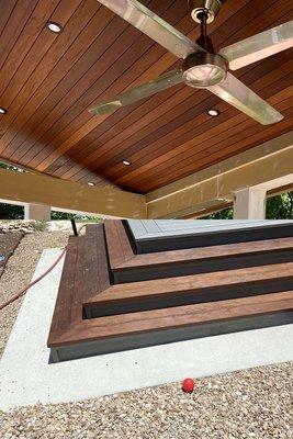 Detail-driven: A tongue and groove Ipe ceiling with recessed lighting and elegant outdoor stairs, crafting a luxurious outdoor ambiance.