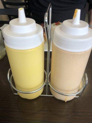 Two sauces -- the yellow pepper one is mild and the red pepper is hot