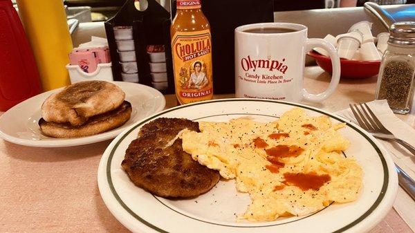 Scrambled eggs and sausage with English muffin and coffee... delicious