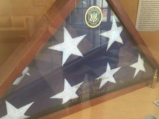 Lobby display case honors a US Army Soldier & Veteran with the folded flag properly on display in a wooden case.