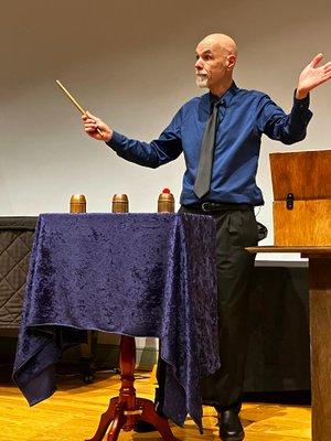 A cups and balls sequence from Drew's award winning magic act.