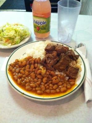 White rice with pink beans with goat stew