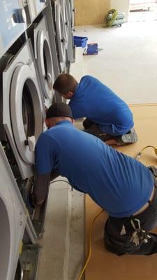 Our techs out in the field installing new commercial laundry equipment.