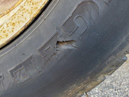 Gash in tire to where you can see the inside mesh of the tire wall