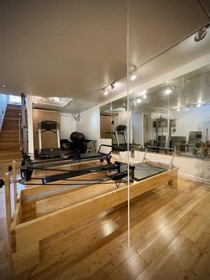 Plexiglass separated Pilates stations