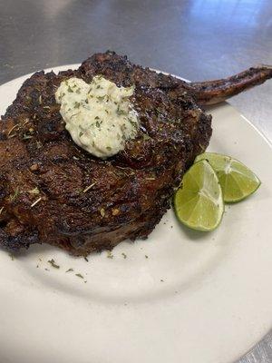 Tomahawk steak Topped with lime and lemon zest and compound butter