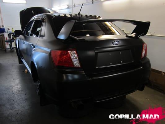 2014 Subaru Sti full vinyl wrap in Satin Black. By Gorilla Mad Film Wraps