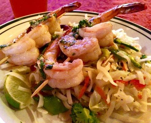 Marinated jumbo grilled shrimp served with a thai rice noodle salad with scallions, broccoli, carrots, show peas, thai basil and cilantro.