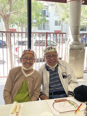 A cute couple wearing the crowns they created