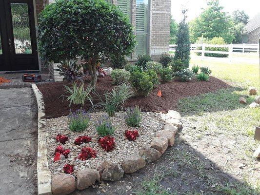 Rock border with septic rock in corner and the plant list