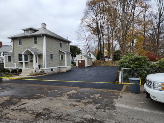 New asphalt paved driveway installed .