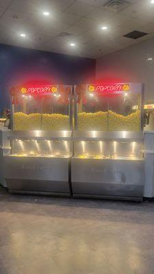 Self-serve popcorn kiosks. Fill your buckets with popcorn and butter as you wish!