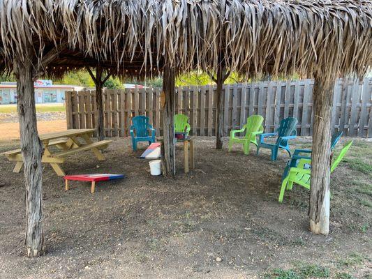 Gazebo with chairs and a cornhole board for your entertainment.