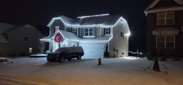 Bright White Christmas lights. Gingerbread style and stone pillar wrapped