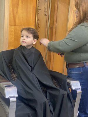 Sitting so still and quite while getting his first haircut