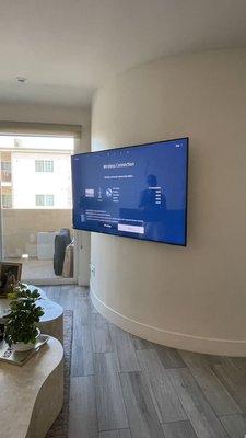 Tv on curve wall with running cords inside the wall