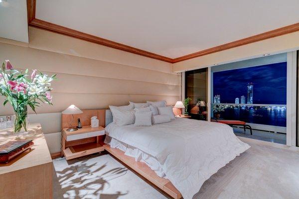 One Of Two Master Bedrooms With Night View Of The Ocean