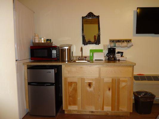 Small kitchenette, microwave, small ice maker, fridge, toaster and coffee pot.