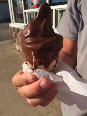 Messily dipped chocolate baby cone- all over the place