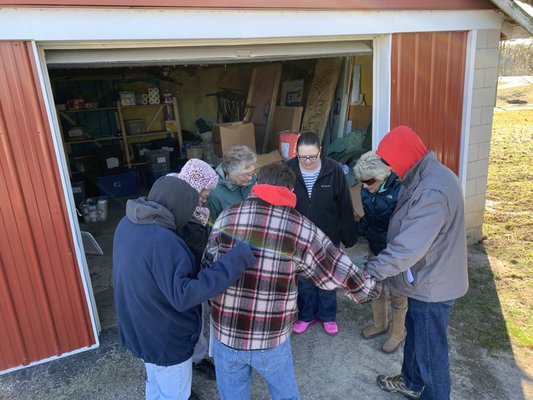 A Little Love team visits community member in need and distributes food donations.