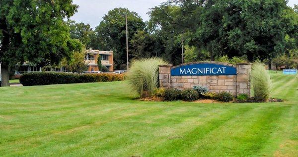 This shows the principal monument sign, an open house sign beyond, and part of the high school building (no review)