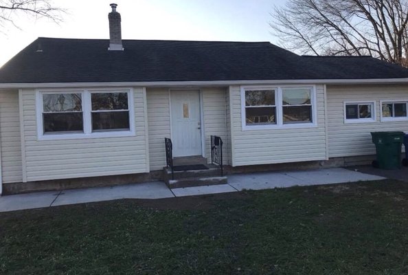 Photo of house with the new siding installed by HM General Construction.