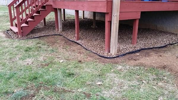 We clean up and apply  some river rock under the deck.