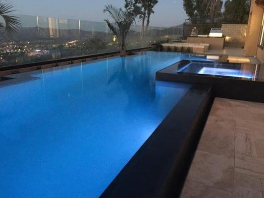 Infinity edge pool design allows this contemporary pool to rise up above the rest.