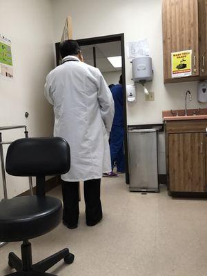 Here's the doctor giving us his back while taking a personal phone call for about 10min. Ever heard of an office..?