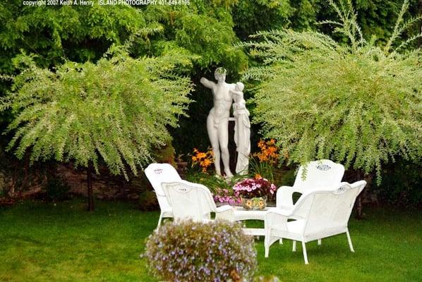 Enjoy our garden with our famous Greek statue.