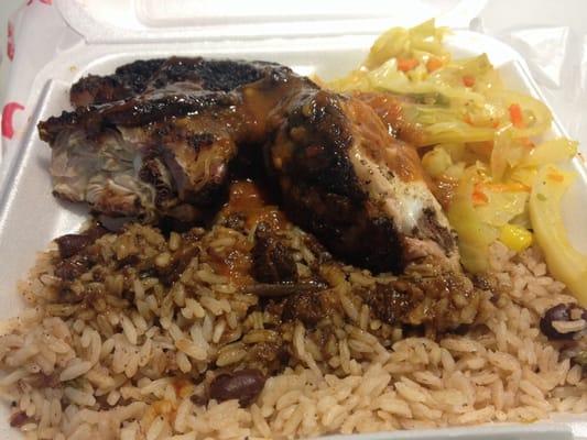 Jerk chicken over rice with veggies.