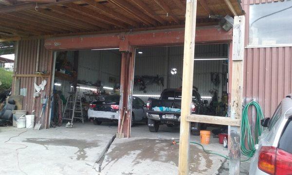 Two cars getting body work done