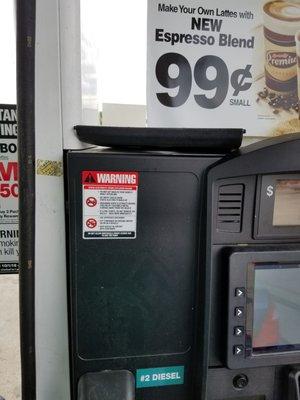 The front to the broken towel dispenser lying on top of the pump