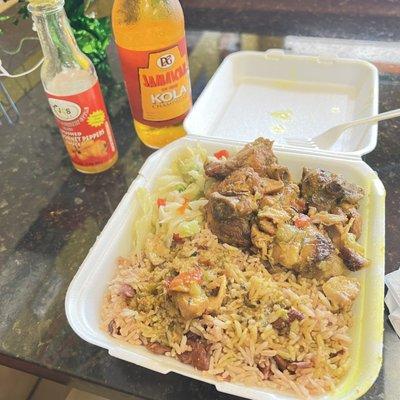 Curry chicken, rice and beans, cabbage and Jamaican soda