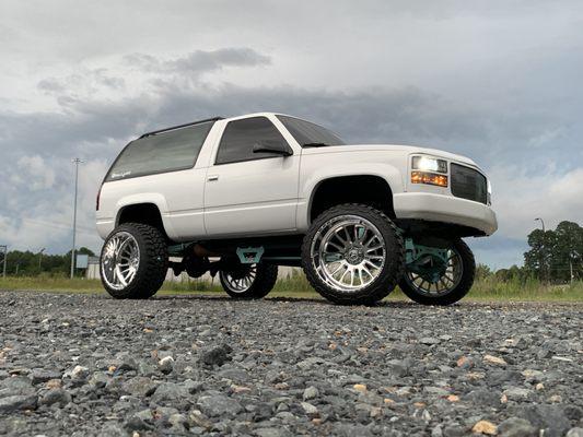 6" Fabtech lift 
 upgraded Stealth shocks
 24x14 American Force wheels (Nemisis) 
 custom rear bumper, paint, and tint.