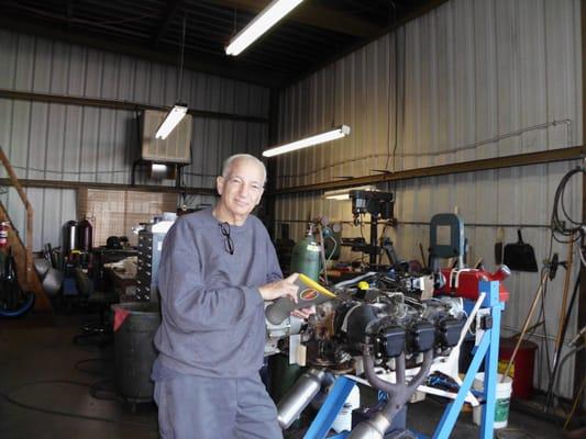 Pete standing next to the reciprocating engine test stand.