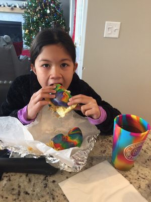 Rainbow bagel with her rainbow cup