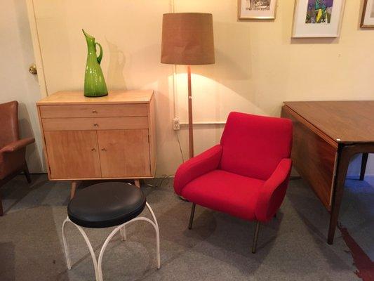 Petite red upholstered chair in the basement