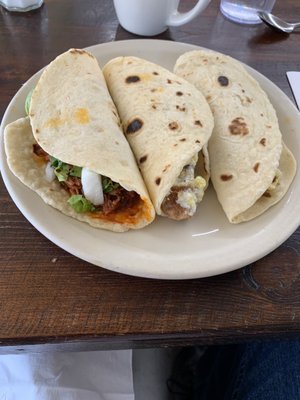 Cabrito, chicharron con huevos, machacado from left to right