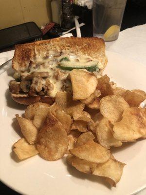 Cheesesteak sub sandwich and chips