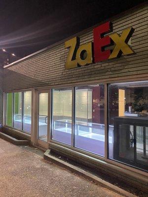 Store front with view of our custom display cases at night