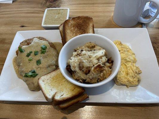 Chicken fried steak, scrambled eggs, Parmesan bake, and white toast