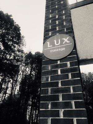 LUX massage is located (on the Left side) upstairs in the second building behind School of Rock.