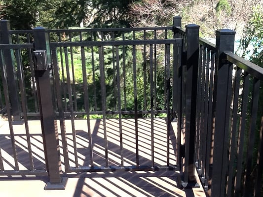 Gate at landing at top of stairs with latch, lock and key and switch for stair lights