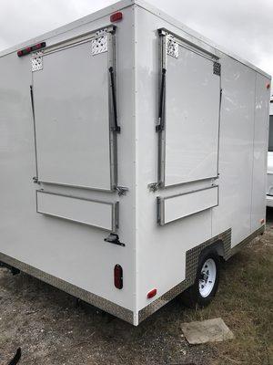 A 7'9" x 10' Food Concession Trailer with back and side service windows.