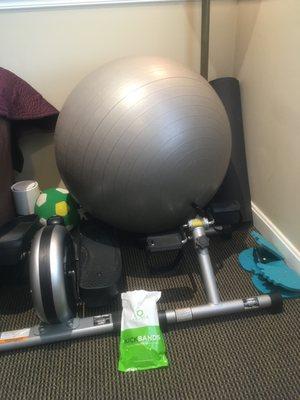 Dr. Heller's feet fidget corner. Desk bike, elliptical, kick bands, yoga ball, and other items for clients to use during appointments.