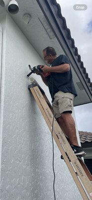 Steve drilling a hole in the concrete to run a new line set! Good job Steve!