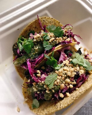 Beef Rendang Tacos: Indonesian Beef Curry with housemade cabbage slaw and salsa roja, topped with cilantro and peanuts!